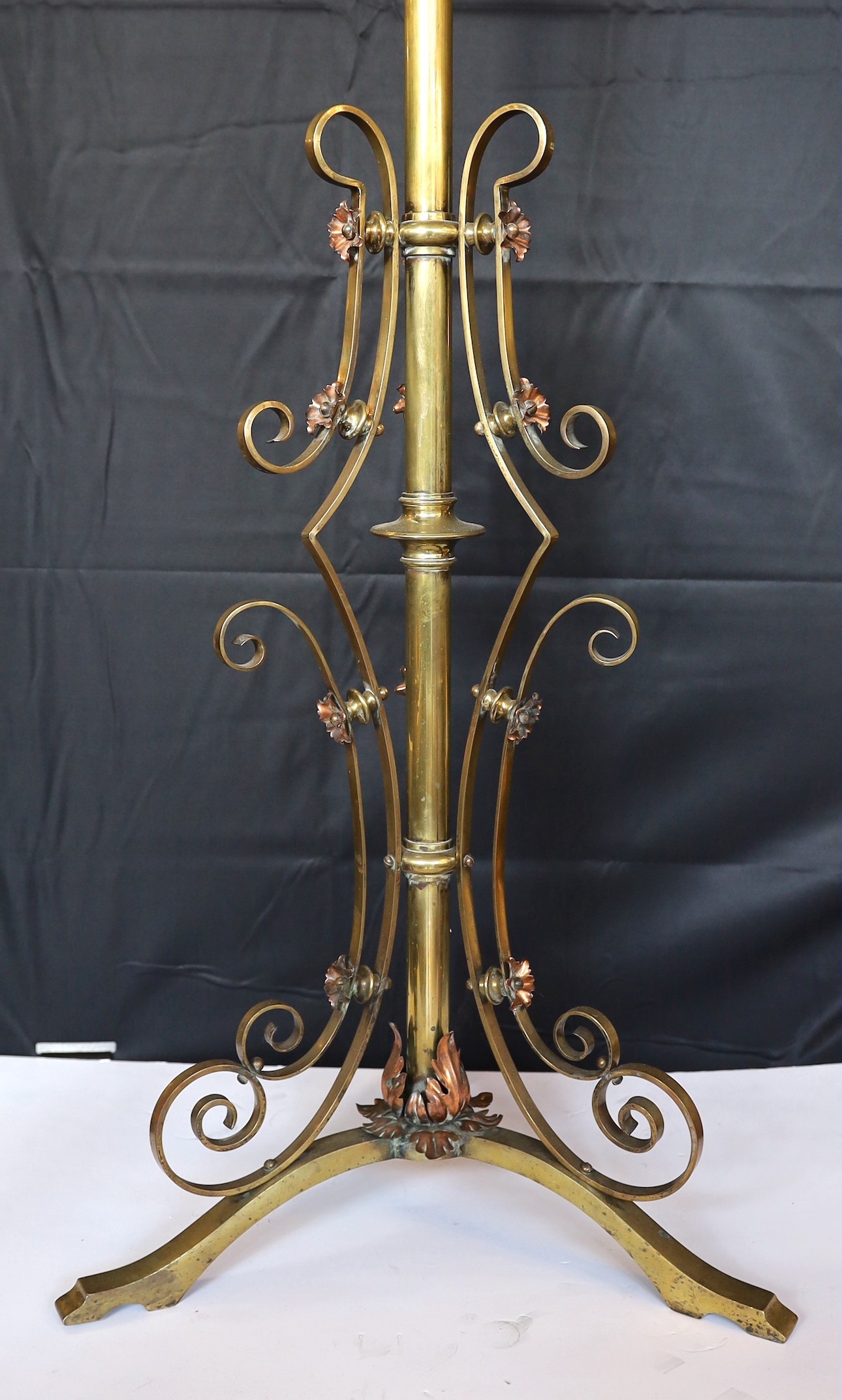 A late 19th century English brass and copper telescopic lamp standard, converted to electricity, height 148cm. width of base 50cm.